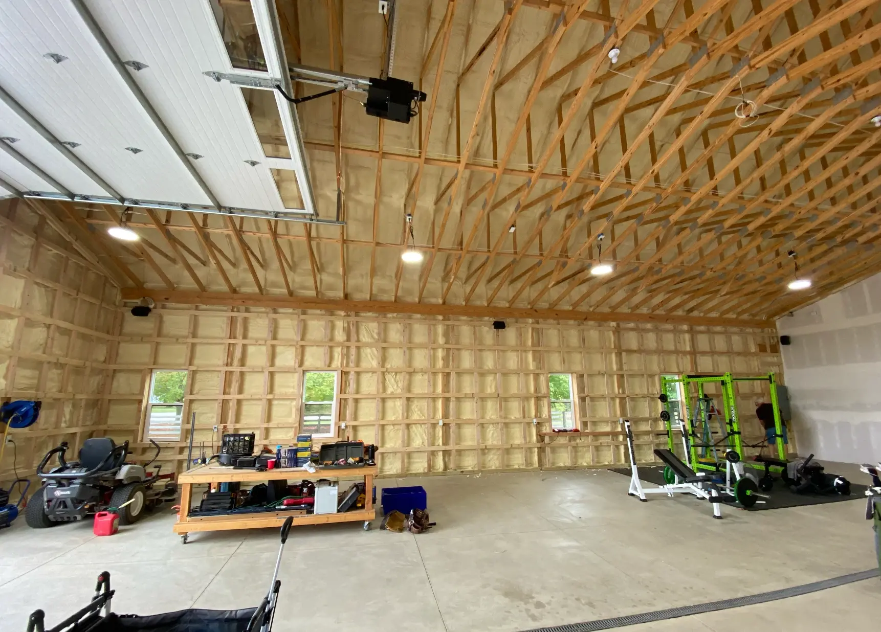 Pole barn garage before, exposed spray foam insulation and bare framing